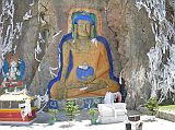 Tibet Lhasa 01 03 Buddha Rock Painting Just Outside Lhasa On arrival at Lhasa�s Gonggar airport, we had to pass through a special security screen which actually took our temperature. After clearing immigration and customs we met our guide Jigme and our Landcruiser driver Panchoul. We stopped just 11km from Lhasa to admire a large and colourful Buddha carved into the base of a cliff. This used to be behind a small lake, but they�ve filled in the part next to the statue with gravel, so now you can walk directly there.